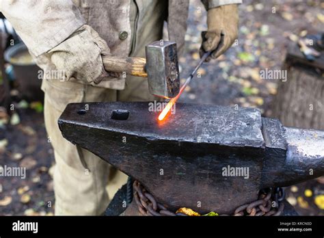 Blacksmith Hammering Hot Steel Rod On Anvil Stock Photo Alamy
