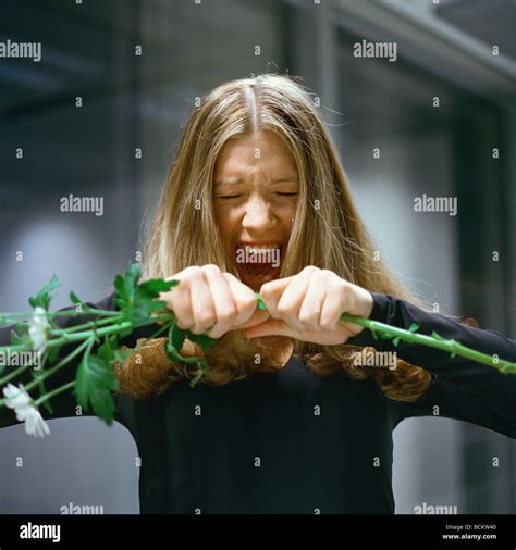 Woman Holding Out Flowers Screaming Stock Photo Alamy