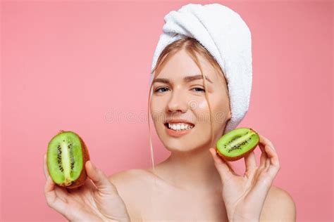 Portrait Of An Attractive Cheerful Woman With A Towel Wrapped Around