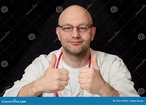 Portrait Of A Bald Doctor In White Uniform And Red Stethoscope And