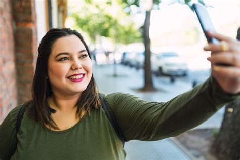 Free Photo Portrait Of Young Plus Size Woman Taking Selfies With Her