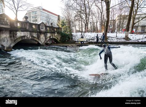 Surfer Riding Upstream Wave In The Eisbach River In Munich Germany
