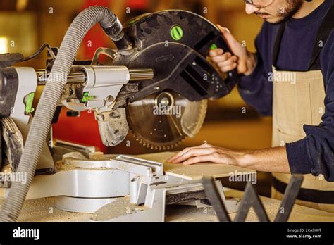 Young Caucasian Hard Working Carpenter Using Circular Saw Craftsman