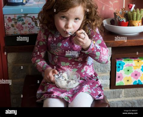 Little Girl Eating Pudding Stock Photo - Alamy