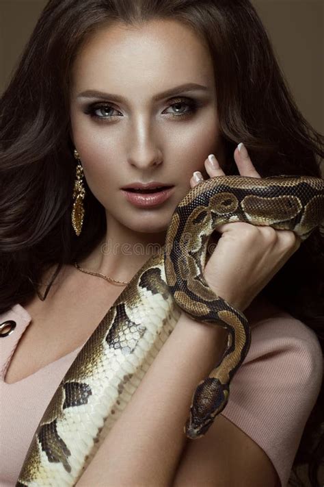 Beautiful Girl Brunette Model Perfect Curls And Evening Fashion Make Up With A Snake In Her