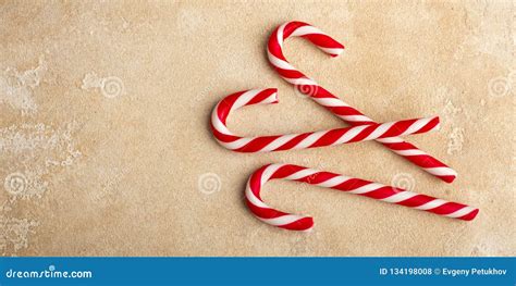 Three Red and White Striped Candy Canes, Lie on a Beige Table. Stock Photo - Image of season ...