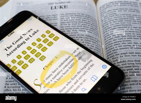 Paper Bible and digital Bible app on smartphone. The New Testament. Gospel. Luke Stock Photo - Alamy