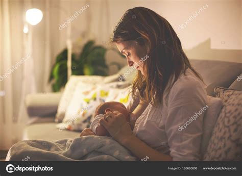 Young Beautiful Mother Breastfeeding Her Newborn Baby Boy At Ni Stock