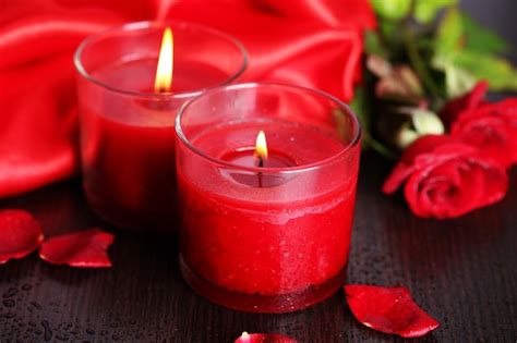 Premium Photo Beautiful Romantic Red Candle With Flowers Close Up