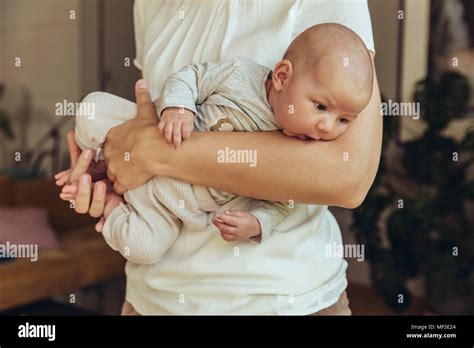 Newborn Baby Being Held In Mother S Arms Stock Photo Alamy