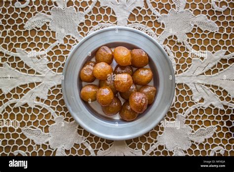 It is a fried batter soaked in syrup, similar to jalebis and churros ...