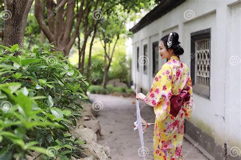 Traditional Asian Japanese Beautiful Bride Geisha Woman Wears Kimono Hold A White Red Umbrella