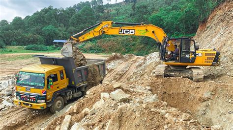 Jcb Excavator Loading Stones Into Dump Trucks Watch This Massive