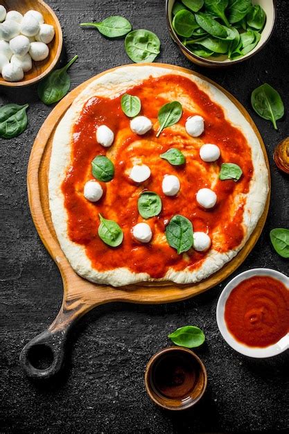 Premium Photo Preparation Pizza Rolled Out Dough With Tomato Paste