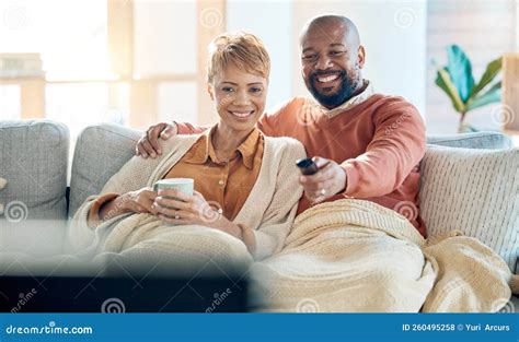 Mature Couple Watching Tv News And Movie Cable Show And Media Broadcast Living Room Sofa And