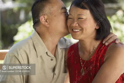 Close Up Of A Mature Man Kissing A Mature Woman SuperStock