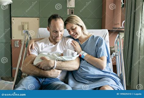 Mother And Father With Her Newborn Baby At The Hospital A Day After A