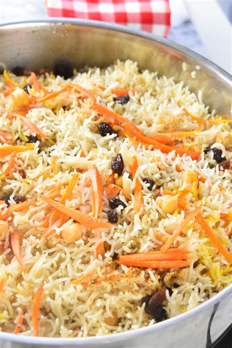 A Pan Filled With Rice And Carrots On Top Of A Stove