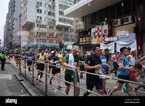 Participants run along Nathan Road during the Hong Kong Marathon 2023 ...