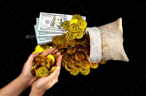 Hand Holding Gold Coin In Treasure Sack And Stack Bundles Of 100 Us Dollars Banknotes Stock