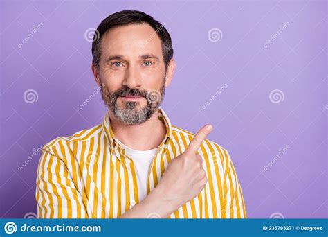 Photo Of Pretty Cute Age Gentleman Wear Yellow Shirt Smiling Pointing Finger Empty Space