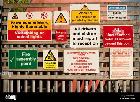 Many Hazard Dangerous Risk Signs On An Oil Depot Entrance Uk Stock