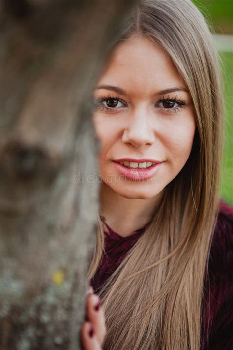 Portrait Blonde Girl Next To A Tree Trunk Stock Photo Image Of Face Outside