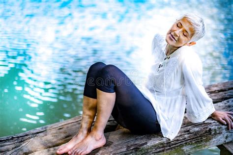 Beautiful Mature Woman Enjoying Peace And Tranquility Of The Nature Stock Photo Image Of Light