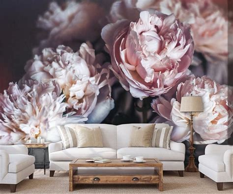 A Living Room With White Furniture And Pink Flowers On The Wall Behind