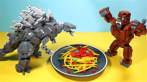 Two Legos Are Standing Next To A Plate Of Food