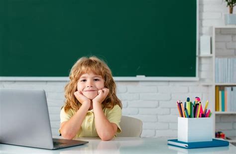 Premium Photo | Cute little school kid boy study in a classroom Online ...
