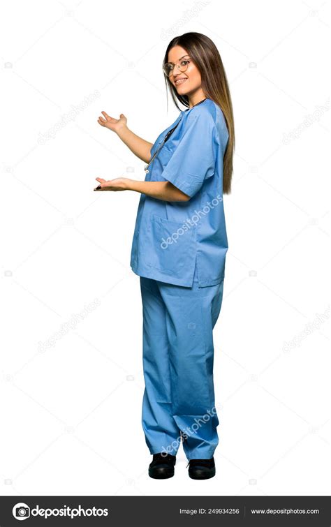 Full Body Young Nurse Pointing Back Presenting Product — Stock Photo