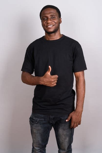 Premium Photo Young African Man Wearing Black Shirt On Gray