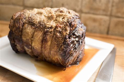 Whole roasted beef joint on a rectangular platter - Free Stock Image