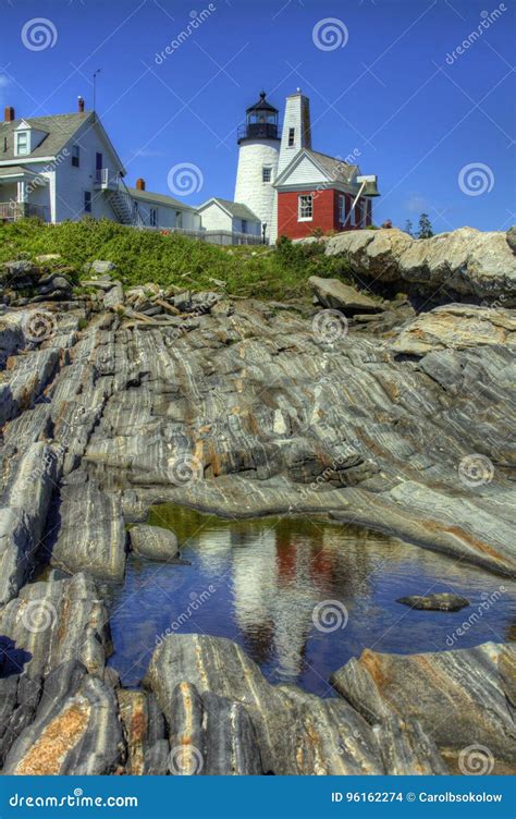 Shimmering Reflection Of Pemaquid Point Lighthouse In A Rock Pool