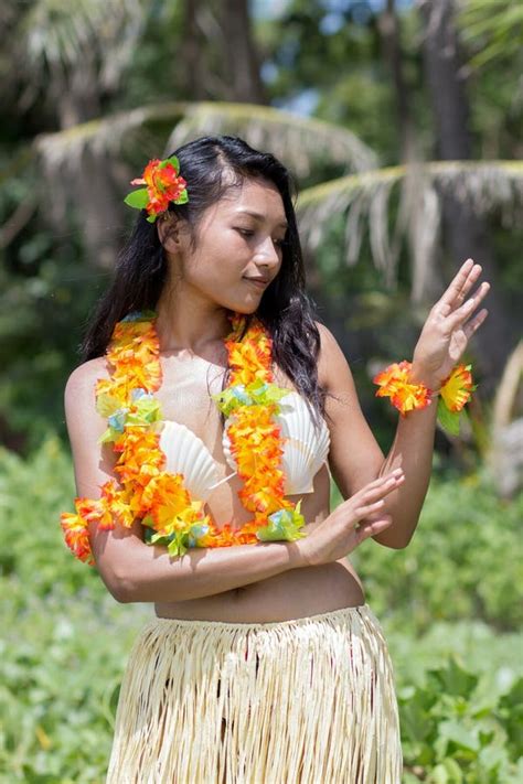 Beautiful Young Polynesian Woman And Man Performing Traditional Hula