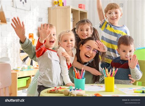Cute Little Children Hugging Nursery Teacher Stock Photo 2420206409
