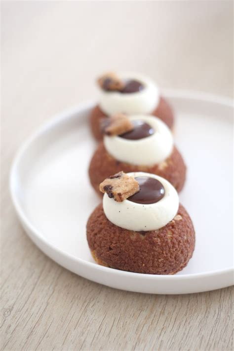 Three Desserts On A White Plate With Chocolate Chips And Marshmallows