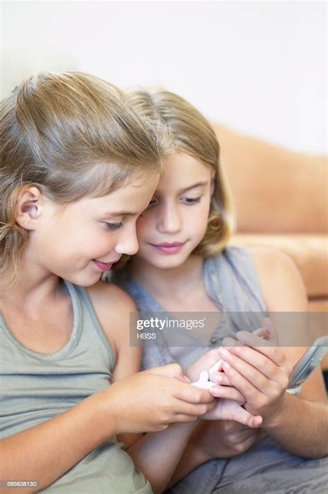 Two Girls With Cell Phones High Res Stock Photo Getty Images