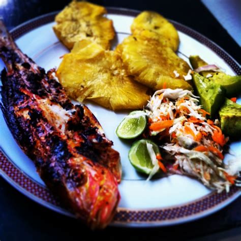 Haitian Dish Grilled Fish And Fried Plantains And Lam Veritab