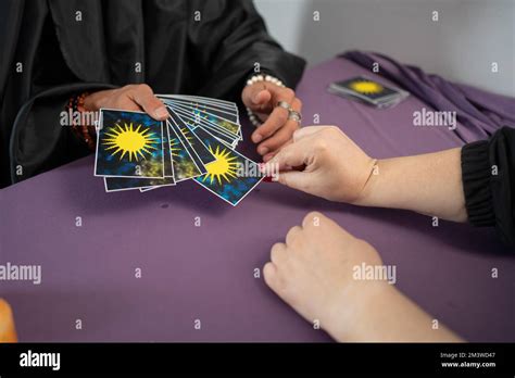 Man Is Reading Tarot Cards Dealing Cards For Woman In Office Stock