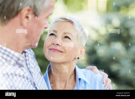 Portrait Of Loving Senior Couple Embracing And Looking At Each Other