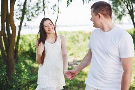 Happy And Young Pregnant Couple Hugging In Nature Romantic Moments