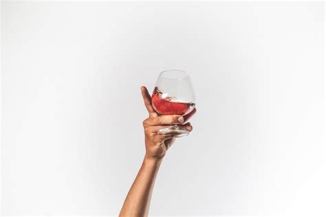 Premium Photo Hand Holding Glass Of Wine Isolated Celebration Concept