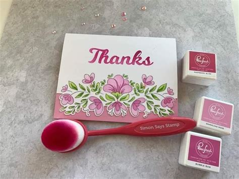 A Pink Toothbrush Next To Some Stamps And A Thank Card