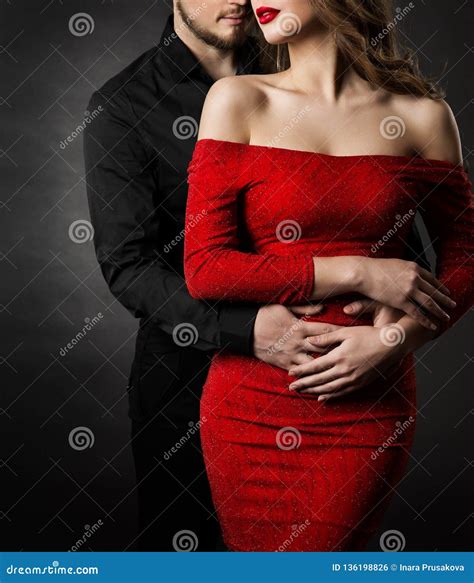 Couple Fashion Beauty Woman In Red Dress And Embracing Man In Love