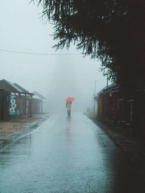 Premium Photo Man Walking On Road During Rainy Season