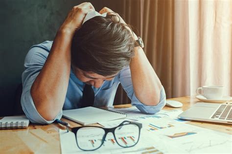 Premium Photo Frustrated Businessman Sitting At Desk In Office