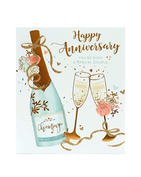 A Happy Anniversary Card With Two Champagne Glasses And Flowers On The