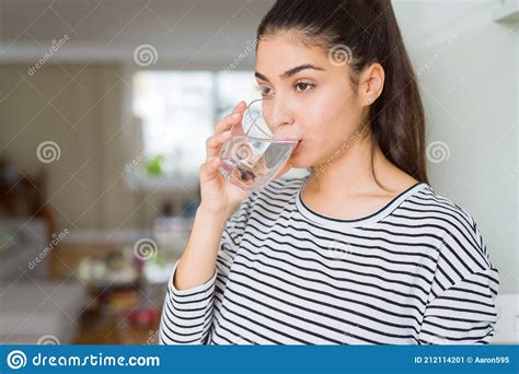 Beautiful Young Woman Drinking A Fresh Glass Of Water At Home Stock